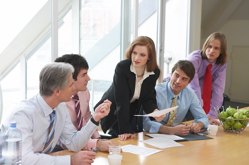 a group of people sitting around a table.