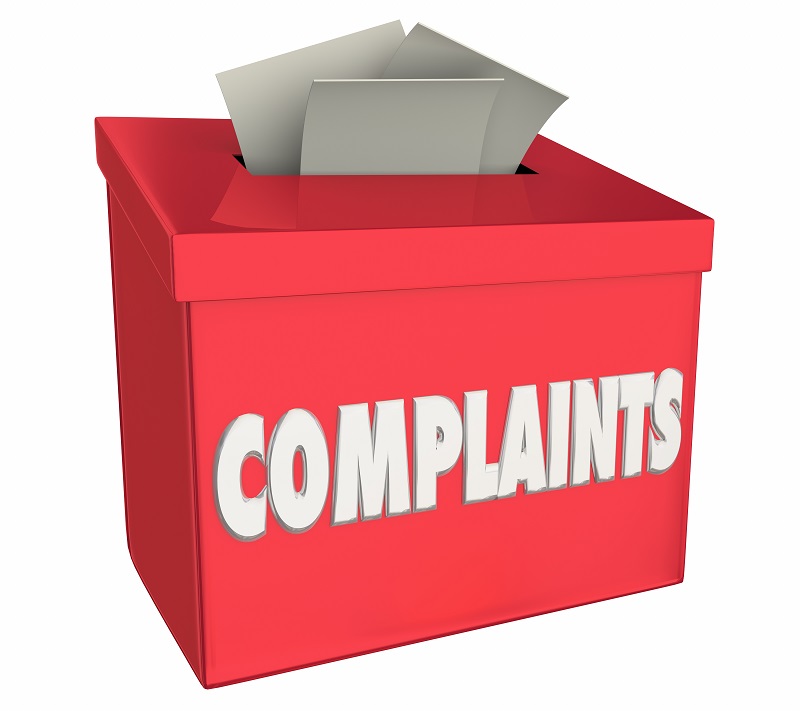 a red box with white text and a few papers in it. Containing the words: complaints