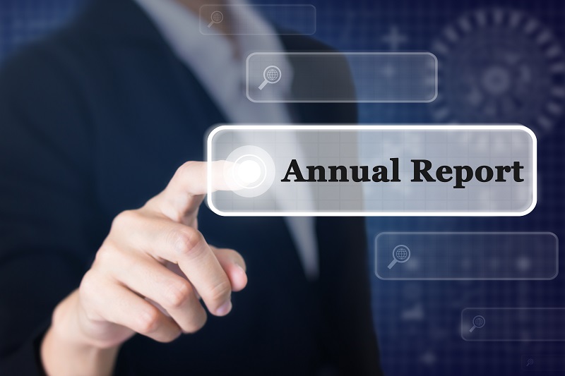 a person touching a button. Containing the words: annual report