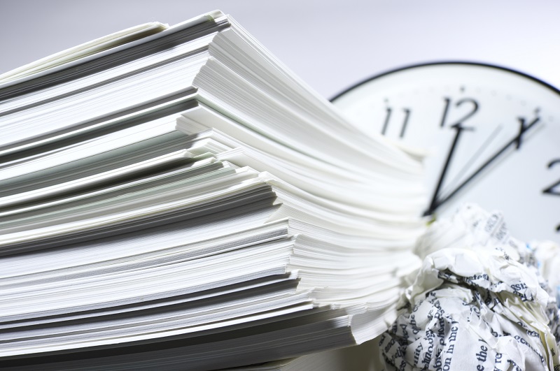 a clock and a stack of papers.