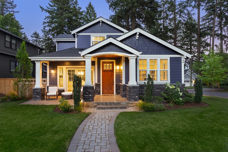 a house with a walkway and lawn.