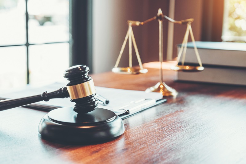 a gavel and scales on a table.