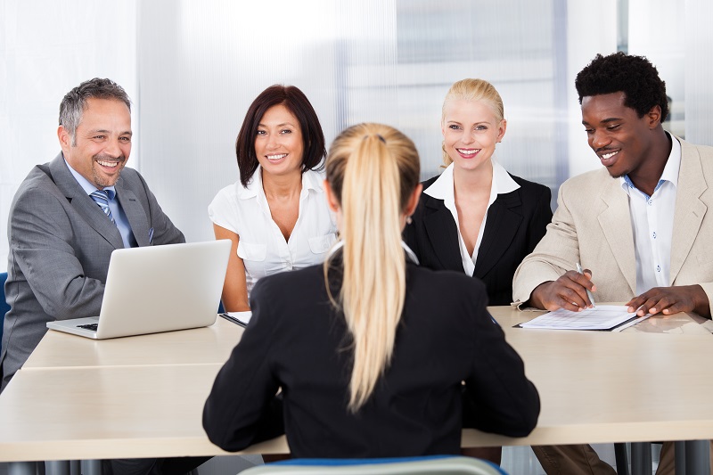 a group of people sitting around a table.