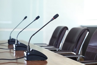 a row of microphones on a table.