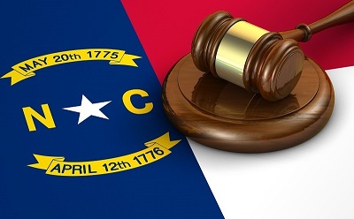 a gavel on a block next to a flag.