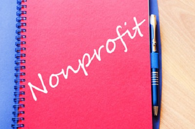 a close-up of a pen and a notebook. Containing the words: nonprofit