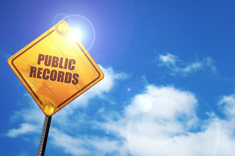 a yellow sign with black text. Containing the words: public records