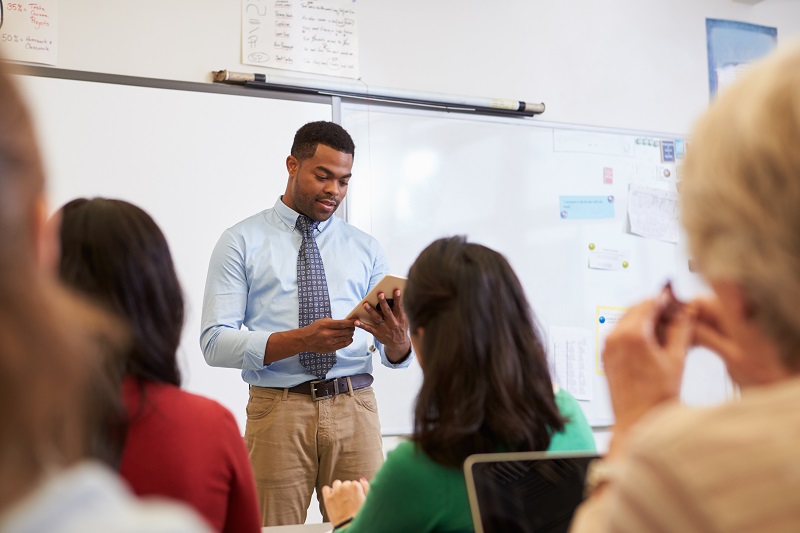 a person standing in front of a whiteboard.