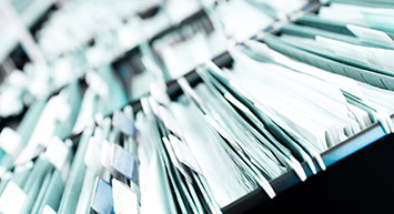 close-up of files in a shelf.