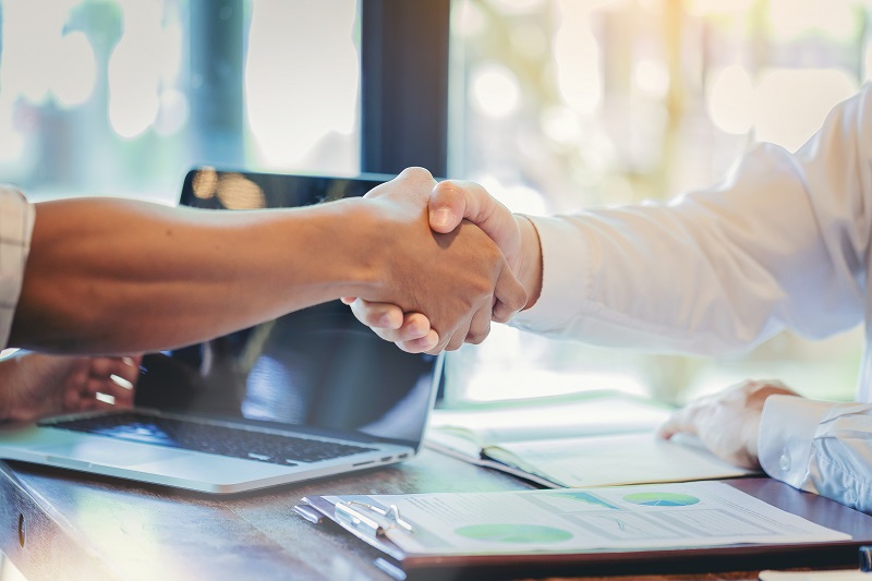 a close-up of people shaking hands.