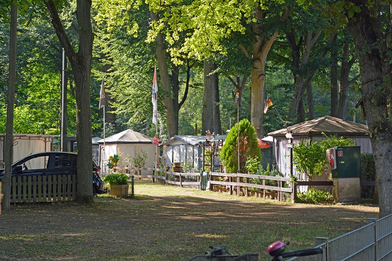 a row of tents in a park.