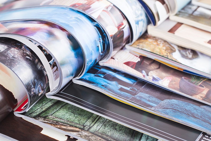 a stack of magazines on a table.