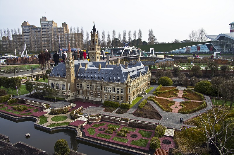 a building with a tower and a pond.