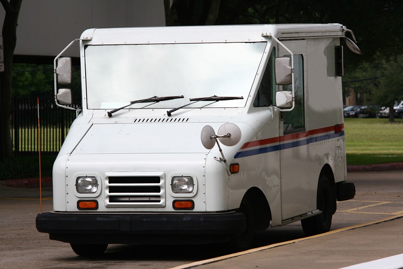 a white van parked on the side of the road.