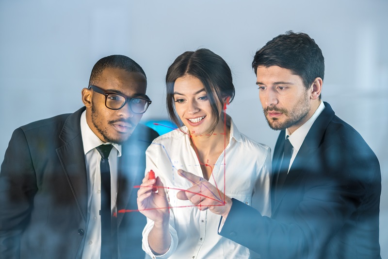 a group of people looking at a diagram.