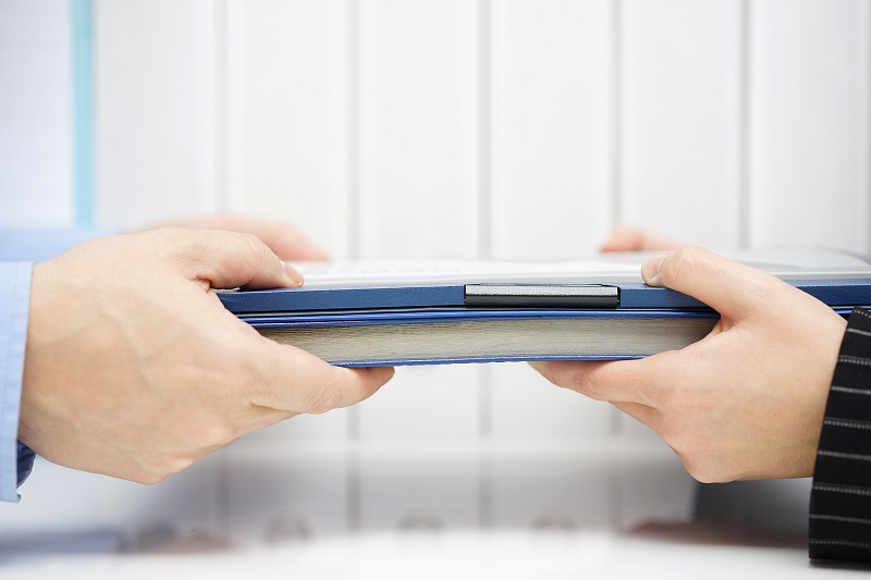 a pair of hands holding a book.