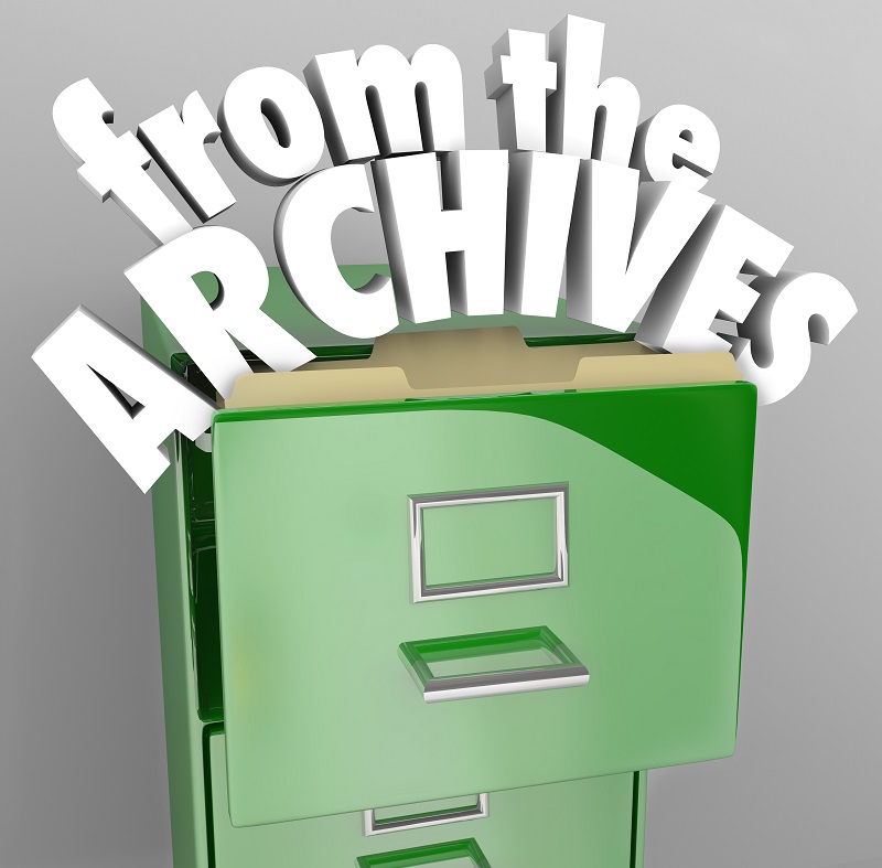 a green file cabinet with white text. Containing the words: rom the archives