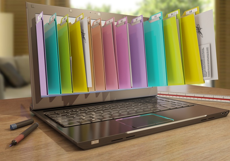 a laptop with personal folders on the screen.