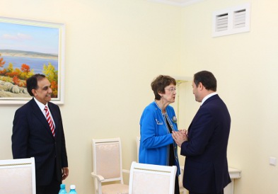 a group of people standing in a room.