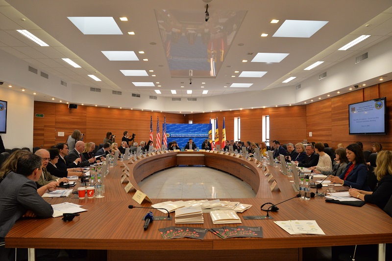 a group of people sitting at a round table.