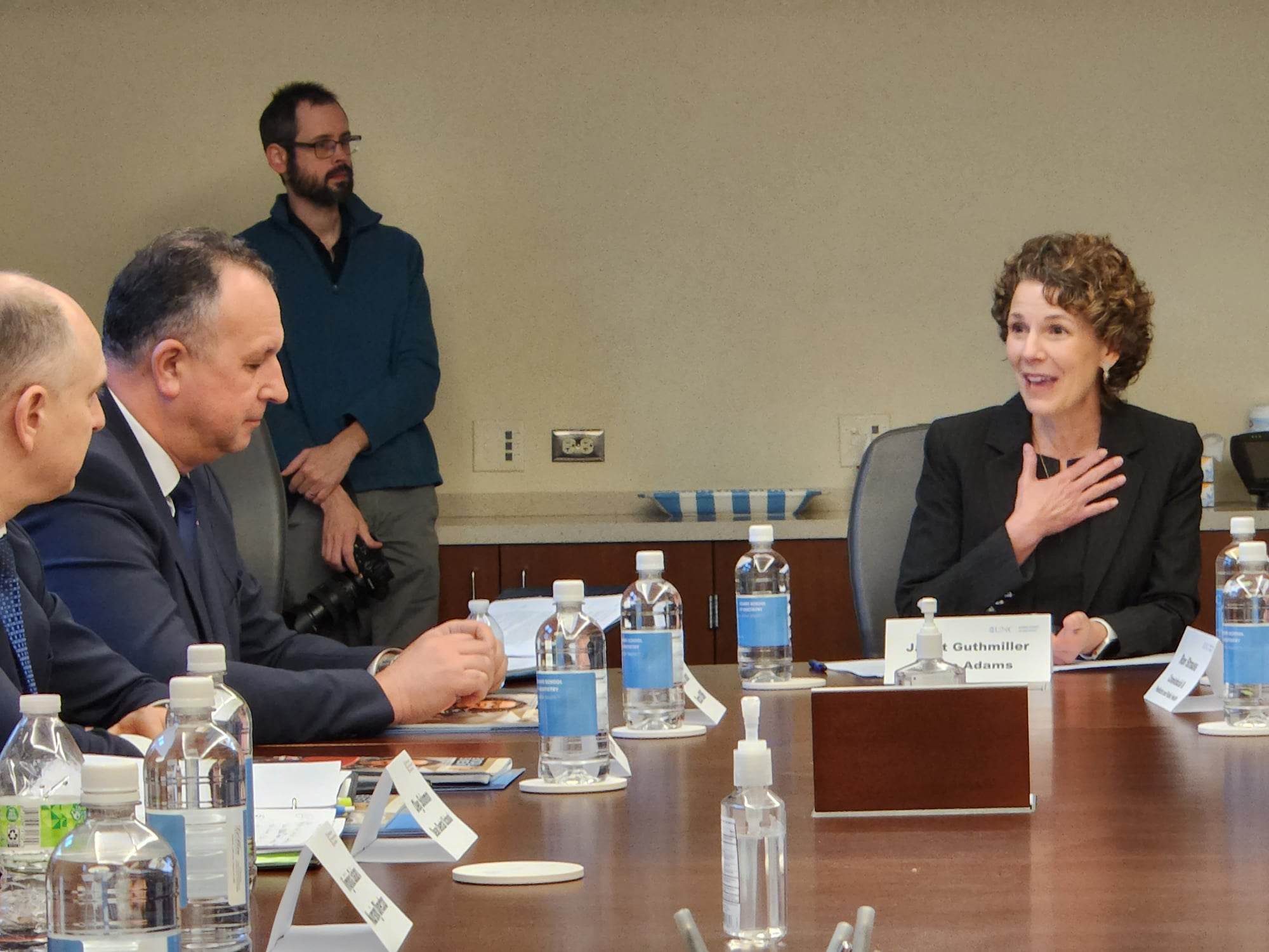 a group of people sitting around a table.