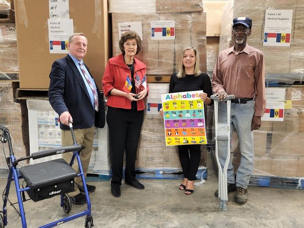 a group of people standing in a warehouse.