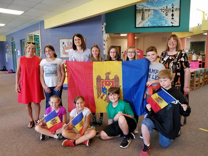 a group of people posing with flags.