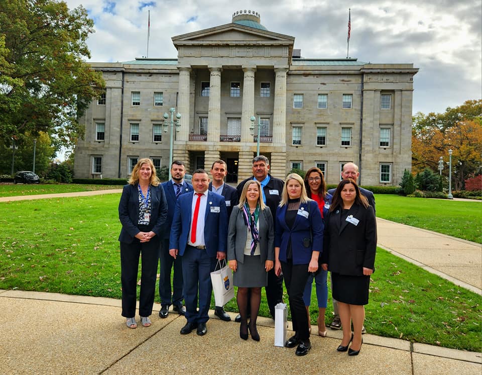 a group of people standing in front of a building.