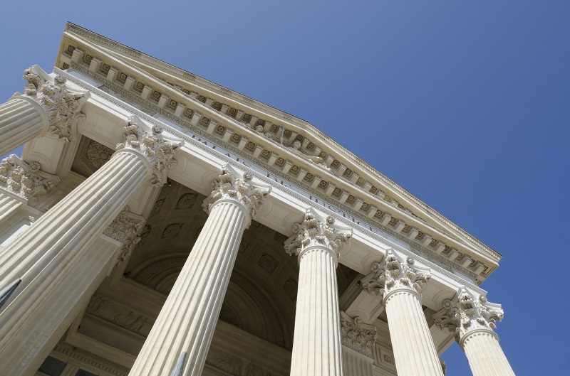 a low angle view of a building with pillars.